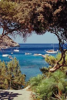 A tranquil Aegean seaside bay with sailboats