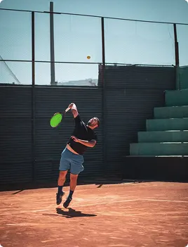 Tennis player on a clay court at serve